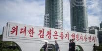 People walk along Ryomyong Street in Pyongyang, North Korea, on August 8, 2023. (Photo by Kim Won Jin / AFP)