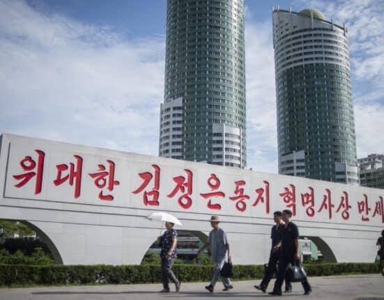 People walk along Ryomyong Street in Pyongyang, North Korea, on August 8, 2023. (Photo by Kim Won Jin / AFP)