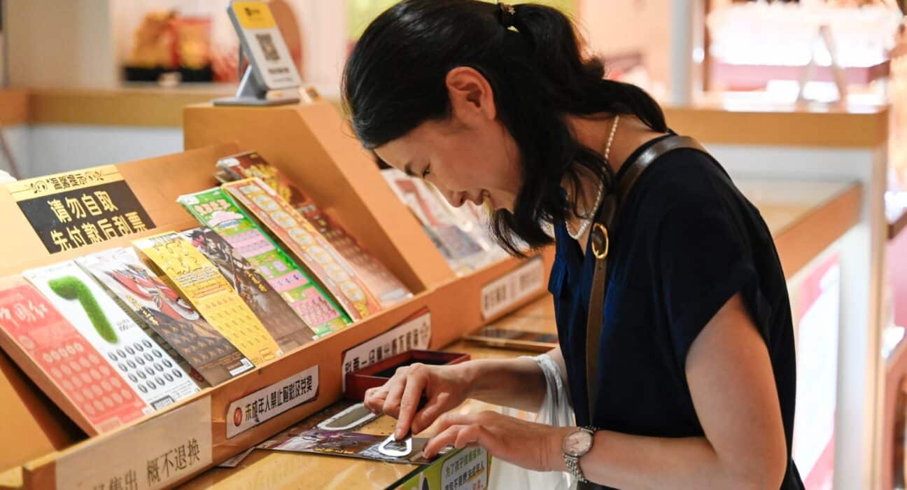 A woman scratching a lottery ticket in China