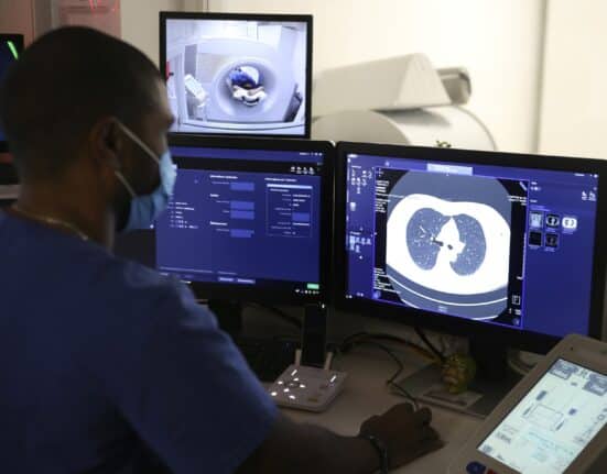 Medical Radiology Manipulator Ludovic Foy look at his screen as he takes a lung scan on a smoking woman for the Acapulco experimentation in Ajaccio on December 16, 2021 on the French Mediterranean island of Corsica. (Photo by Pascal POCHARD-CASABIANCA / AFP)