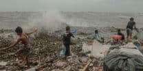 Residents of Baseco in Manila take advantage of Typhoon Egay to collect plastic waste on July 26, 2023.