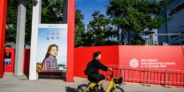 A woman cycles past a poster of South Korean actress Go Ah-sung for the film 'Because I Hate Korea' at the Busan Cinema Center before the opening of the 28th Busan International Film Festival (BIFF) in Busan on October 4, 2023. (Photo by Anthony Wallace/ AFP)