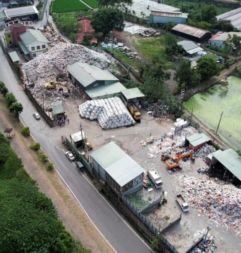This aerial picture taken on October 19, 2023 shows garbage at the Puli Township Sanitation Department office building in Nantou County. A Taiwanese couple dressed in their wedding best embraces each other in front of a mountain of trash -- a photo that the environment-conscious bride said she wanted to show guests to discourage them from generating trash. (Photo by Sean CHANG / AFP)