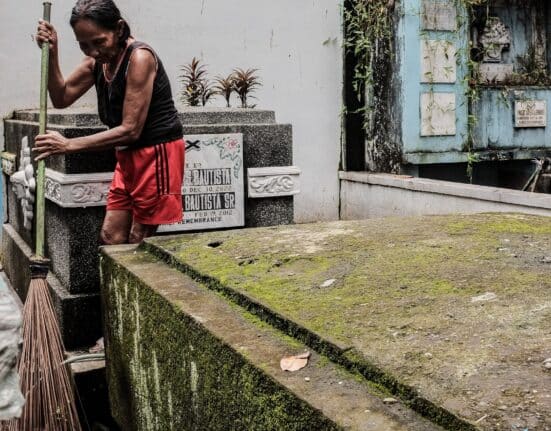 A woman cleans graves at the Manila North Cemetery on Wednesday, Oct. 25, 2023 (Ryan Baldemor/republicasia)