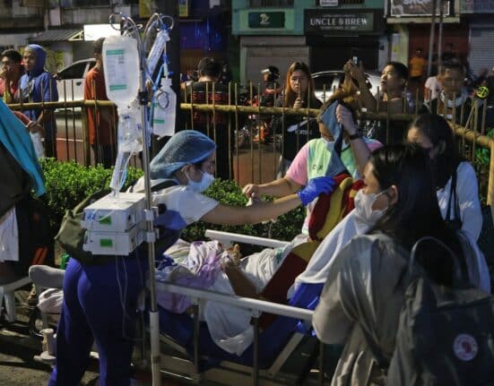 Residents and medical personnel evacuate patients from inside a hospital after a 7.4 magnitude earthquake struck Butuan City, in southern island of Mindanao late December 2, 2023. (Photo by AFP)