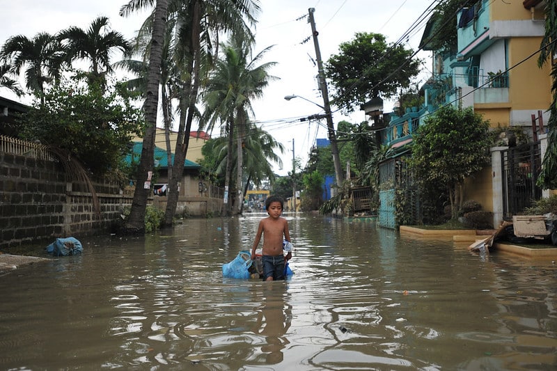 A boy walking along a flooded street caused by Typhoon Ondoy in 2009.